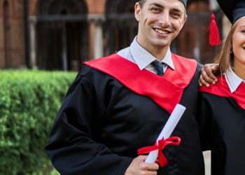 cropped-portrait-three-smiling-graduate-friends-graduation-robes-university-campus-with-diploma-1-scaled-1.jpg