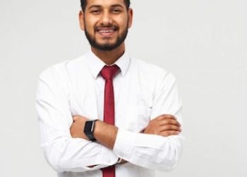 portrait-young-indian-top-manager-t-shirt-tie-crossed-arms-smiling-white-isolated-wall_496169-1513