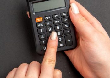 cropped-top-view-black-calculator-female-hands-black-table-free-space.jpg