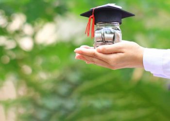 cropped-woman-hand-holding-coins-money-glass-bottle-with-graduates-hat-natural-green-background-1-scaled-2.jpg